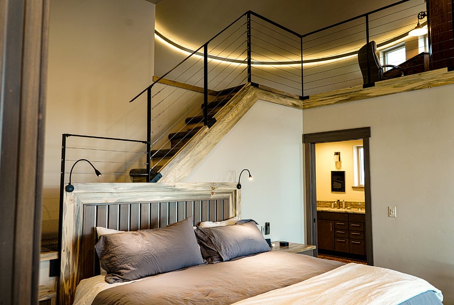 Primary suite with loft office and bathroom in the round.