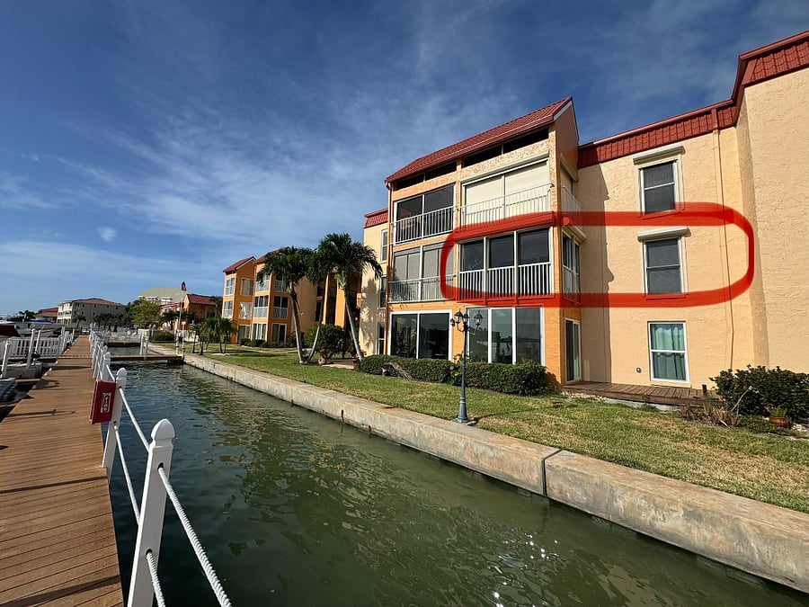 Second-floor waterfront condo with a private screened lanai overlooking Boca Ciega Bay.