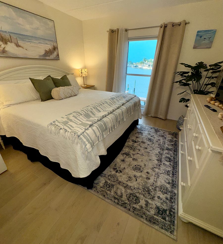 Wake up to peaceful Intracoastal views from the spacious primary bedroom.