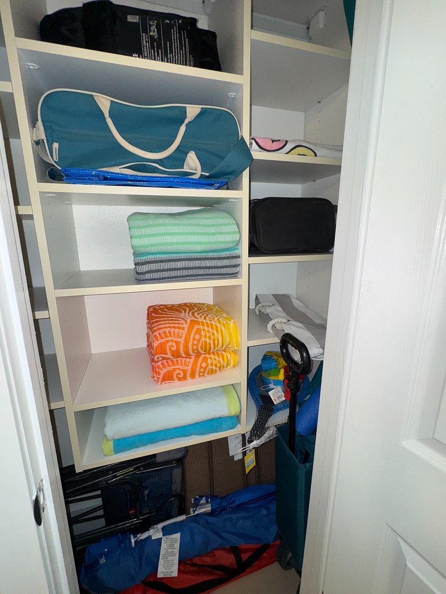 Beach essentials closet stocked with chairs, towels, umbrellas, toys and more for carefree days by the shore