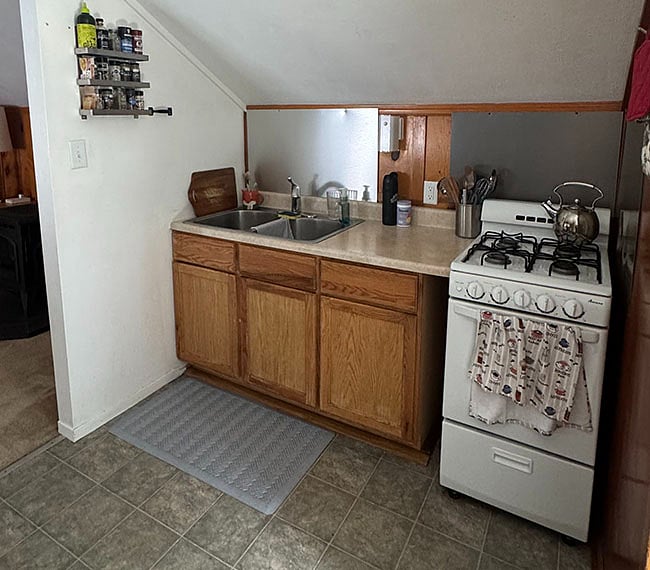 The kitchen is fully equipped with gas range/oven and full-size double sink.