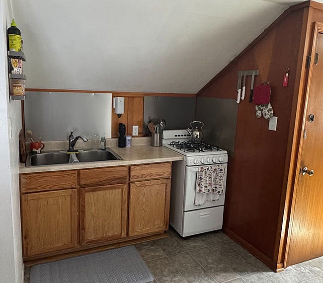 The kitchen is fully equipped with gas range/oven and full-size double sink.
