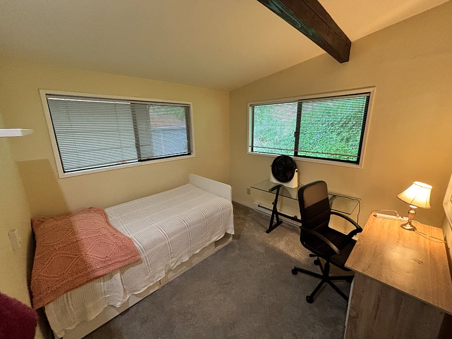 Bedroom off of hall, with twin bed and closet.  Window look out the back into the forest.  