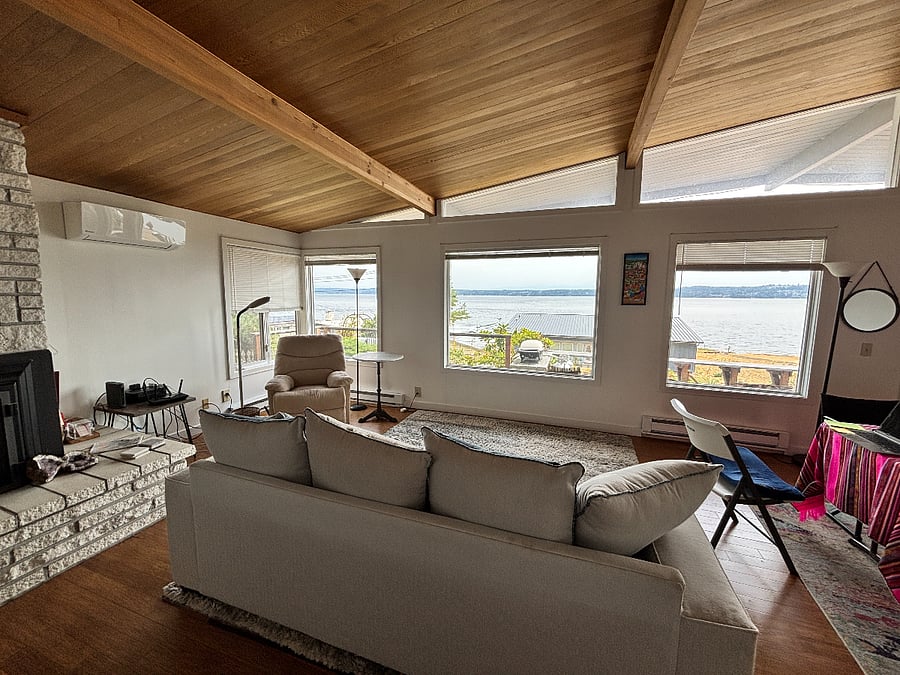 Living room with view windows. Mini split on wall provides heating and cooling for most of the living space. 