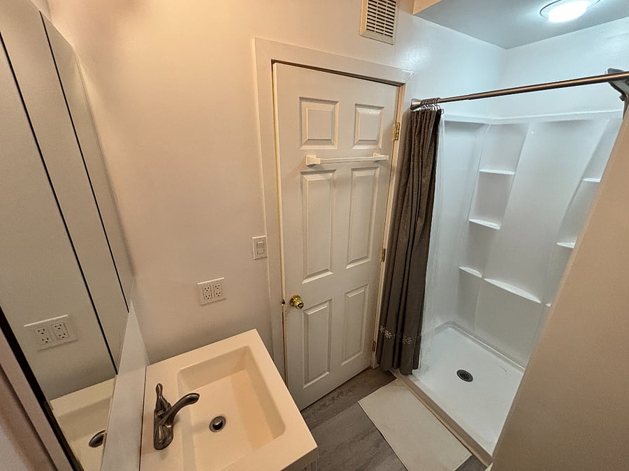 Bathroom and shower off of hall. 