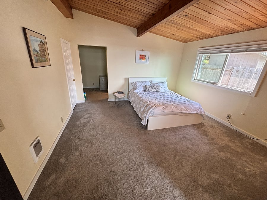 Master bedroom with queen size Sleep Number airbed.  Entry to walk in closet and work area.  