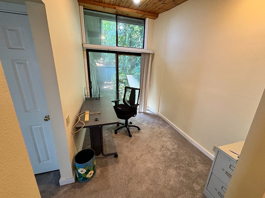 Master bedroom work area, view of back forest and shed. 