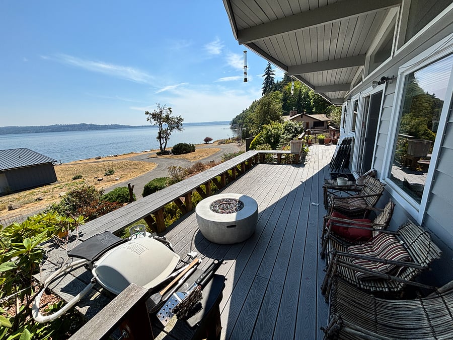 View south from large deck, with chairs and benches. 