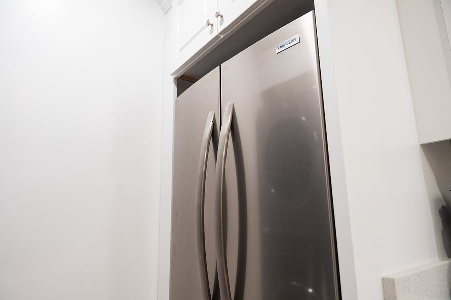Full-size refrigerator with bottom freezer drawer.