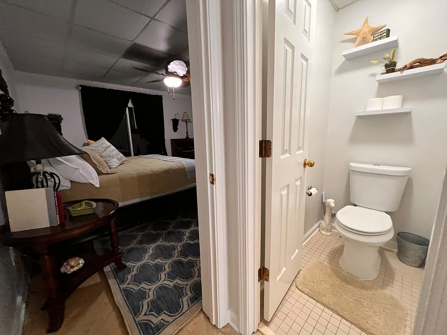 Looking into master bedroom from Master bath ensuite. Toilet room on right.