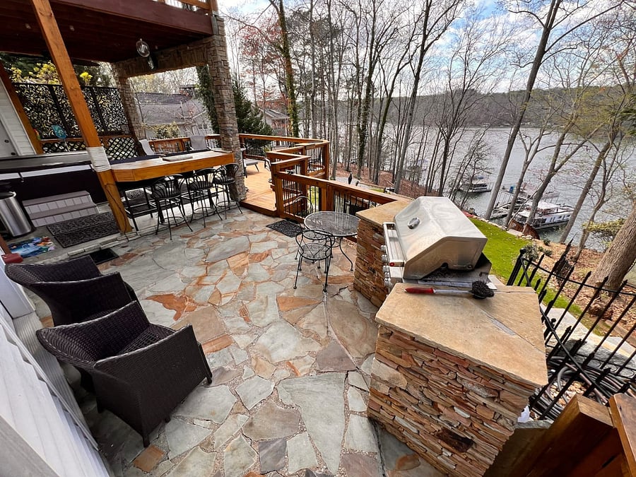 Patio area with Grill, high-top bar, Hot tub and deck overlooking the firepit area and lake