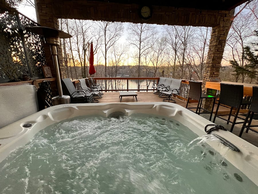 Hot tub is located right outside the back door on the patio.