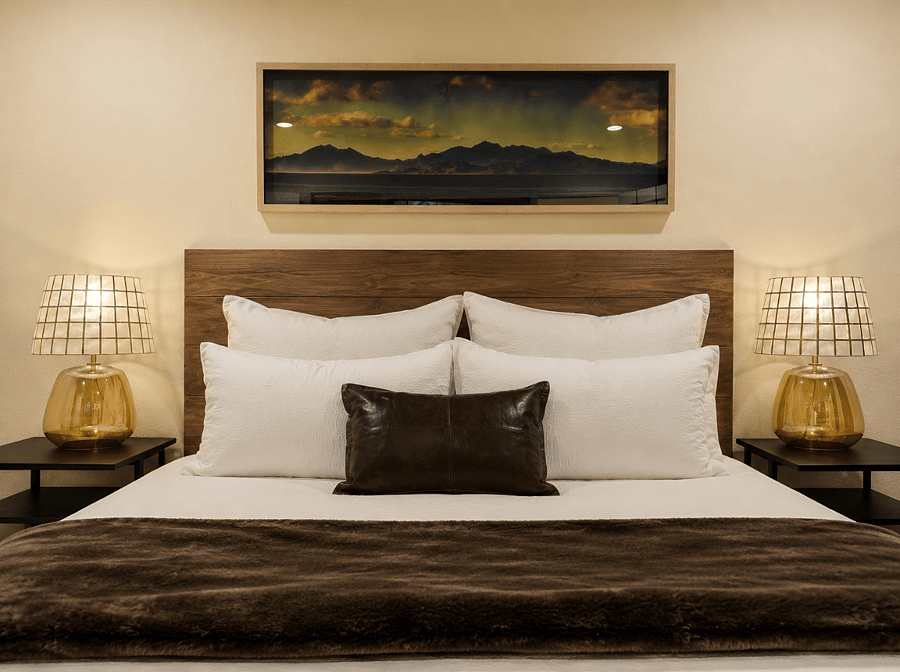 Oversized primary retreat with king bed, luxury hotel-style linens, recessed dimmable lighting, blackout curtains, and a private en suite bath