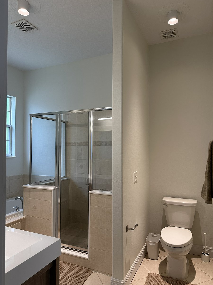 Primary bathroom with dual-sink vanity, walk-in shower, jacuzzi tub, and linen closet
