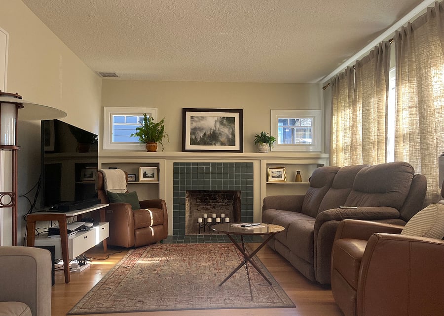 Living area with recliner sofa and smart TV.