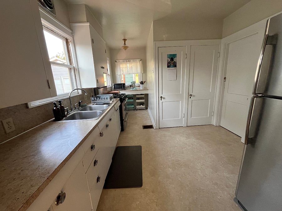 Kitchen area with staircases leading to outside/upstairs