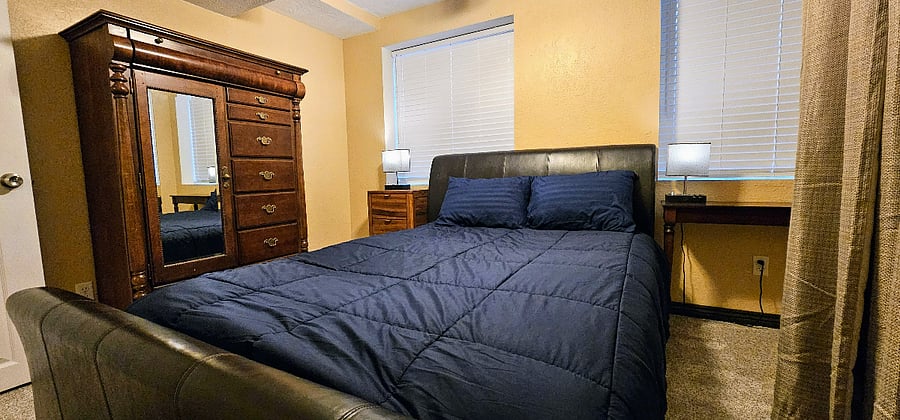 Second bedroom with queen size bed, dresser, nightstands. Full size closet with plenty of hangar and shelving space. Ceiling fan.