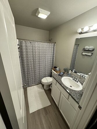 Primary bathroom with shower/tub combo.