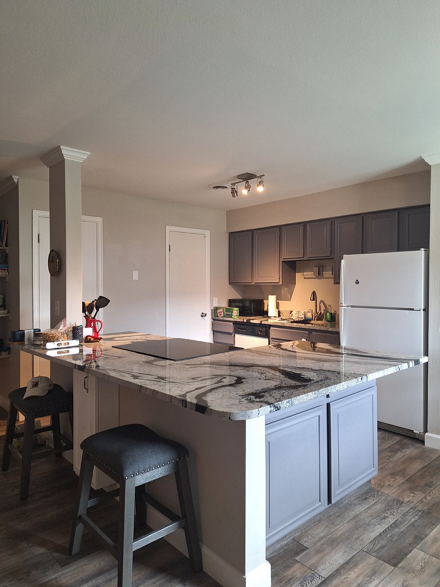Kitchen with granite countertops and flat stove top