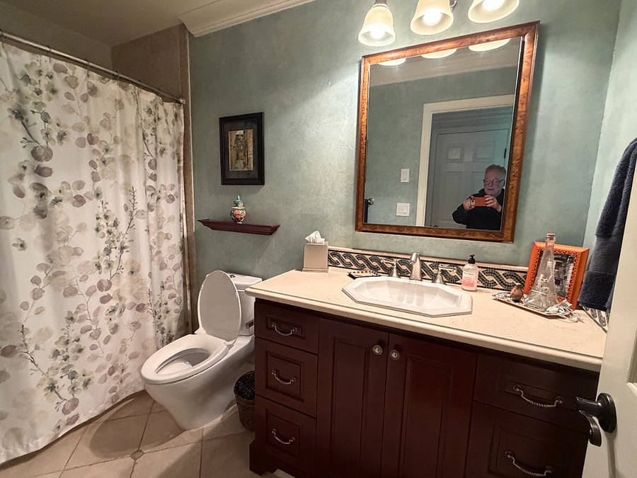 Guest bathroom with my husband in the mirror.