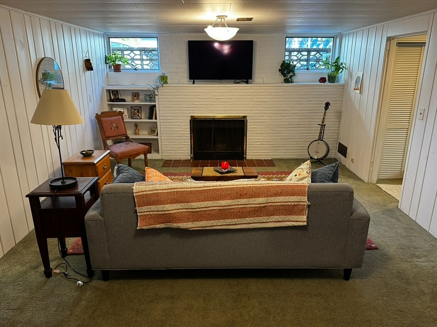 Primary living room space, fireplace and tv