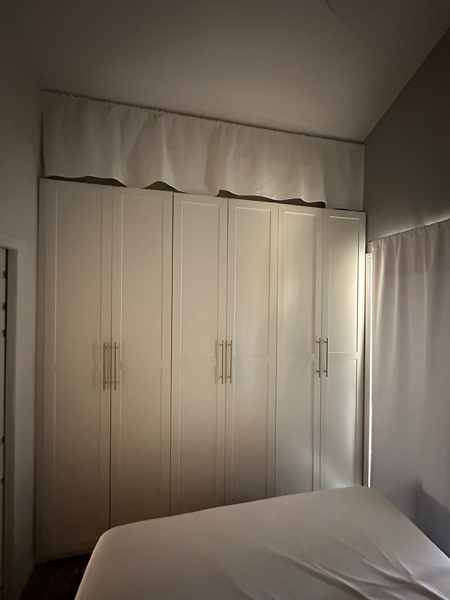 Large custom closet with additional storage on top