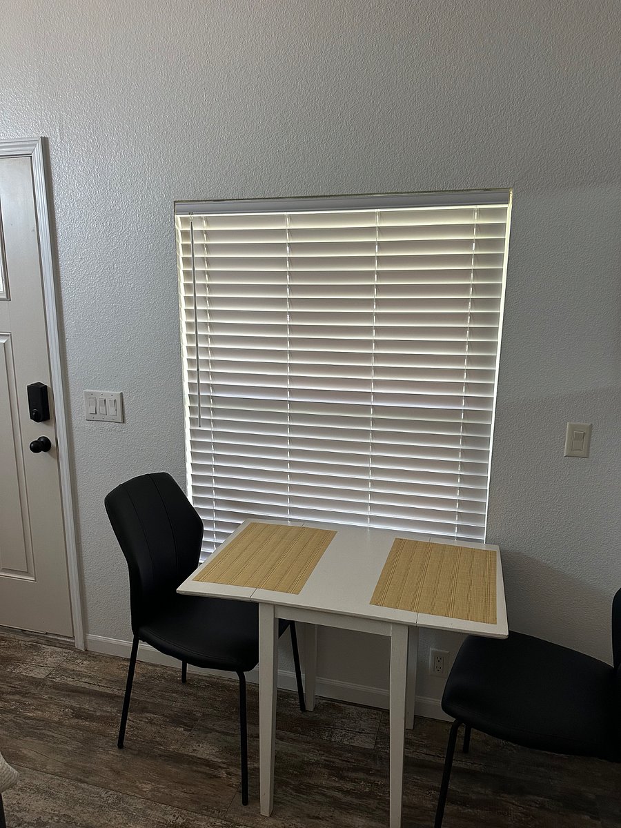 Dining table with 2 chairs and privacy blinds