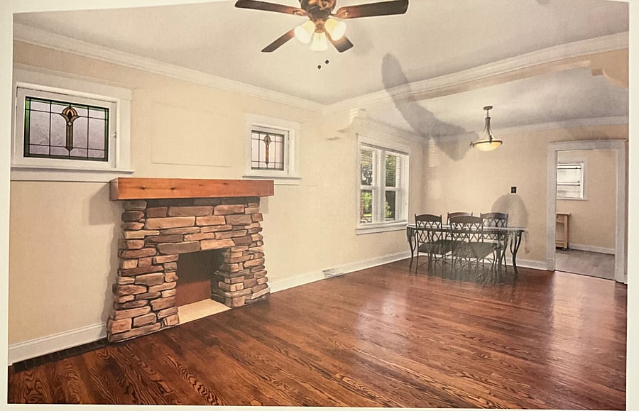 Updated hardwood floors and new windows. Lots of room for a large couch and television on the mantle. Dining room table includes two additional chairs or the leaf can be removed for a smaller option.