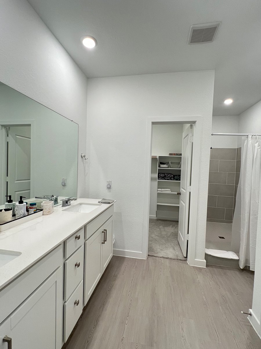 Masters bathroom with walk in closet and standing shower