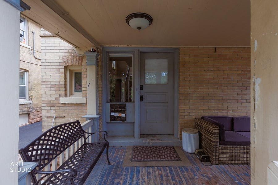 Up the front stairs, a covered porch greets you with the front door ahead and each unit's own private mailbox.