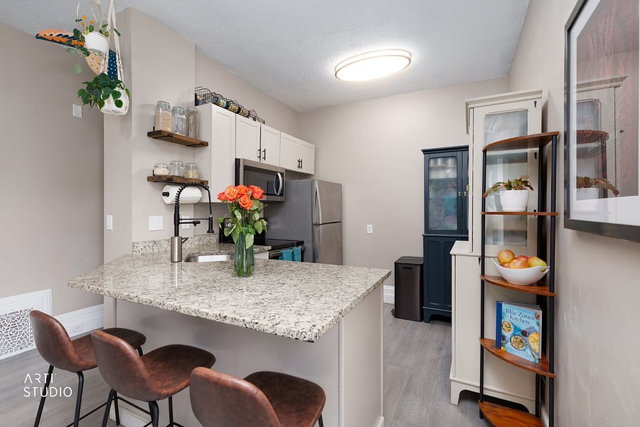 Bar seating for casual meals or morning coffee, with open shelving that keeps produce, everyday kitchen items, or a few personal touches within easy reach.