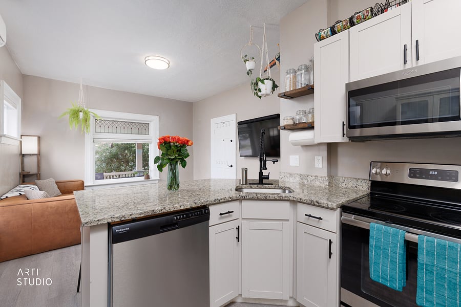 The dishwasher and sink look out over the counter seating, so cleanup stays sociable and you're never cut off from the room while you cook. Every essential is here, dishwasher included.