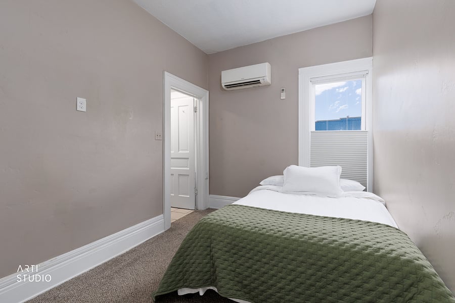 The second bedroom with a full bed, its own closet, and a private attached bathroom, so a guest, child, or roommate has a comfortable space that's fully their own.