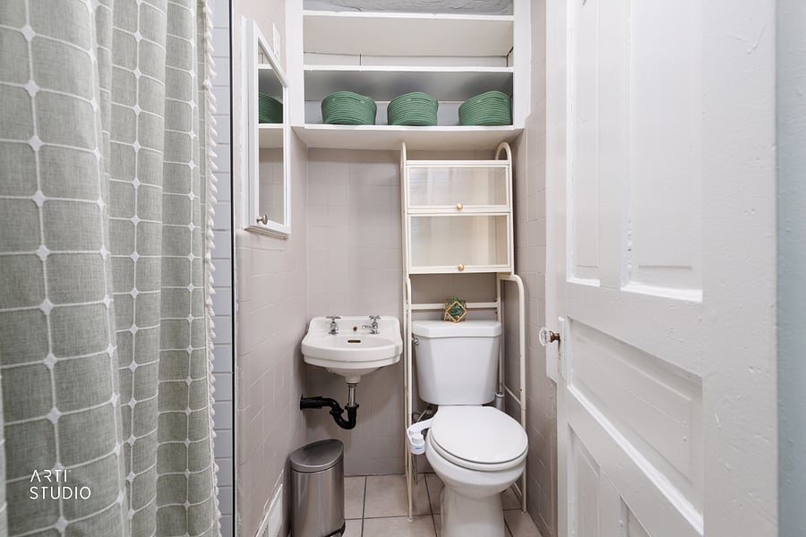 The second bath pairs a roomy two-person shower with dual showerheads and classic subway tile, with clearance that fits someone over six feet comfortably, plus a handheld sprayer for gear or kids.