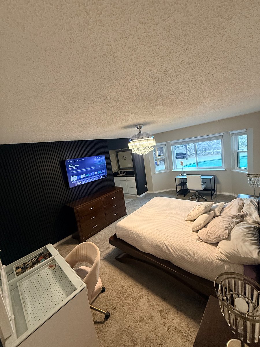 Master bedroom with smart tv, walk in closet, large bathroom, and pool view! 