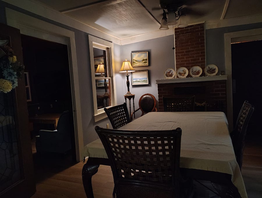 Warm lighting transforms this classic dining room into an inviting evening retreatperfect for sharing a homemade meal, a bottle of wine, and the stories that make every trip memorable.
