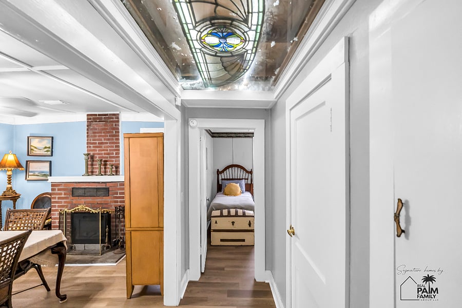 Look up. This original stained-glass transom has welcomed guests for generations, preserving a timeless piece of the home's 1932 character.