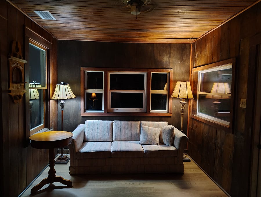Two timeless floor lamps complete the home's collection of classic lighting, creating a warm embrace around the sofa after sunset.