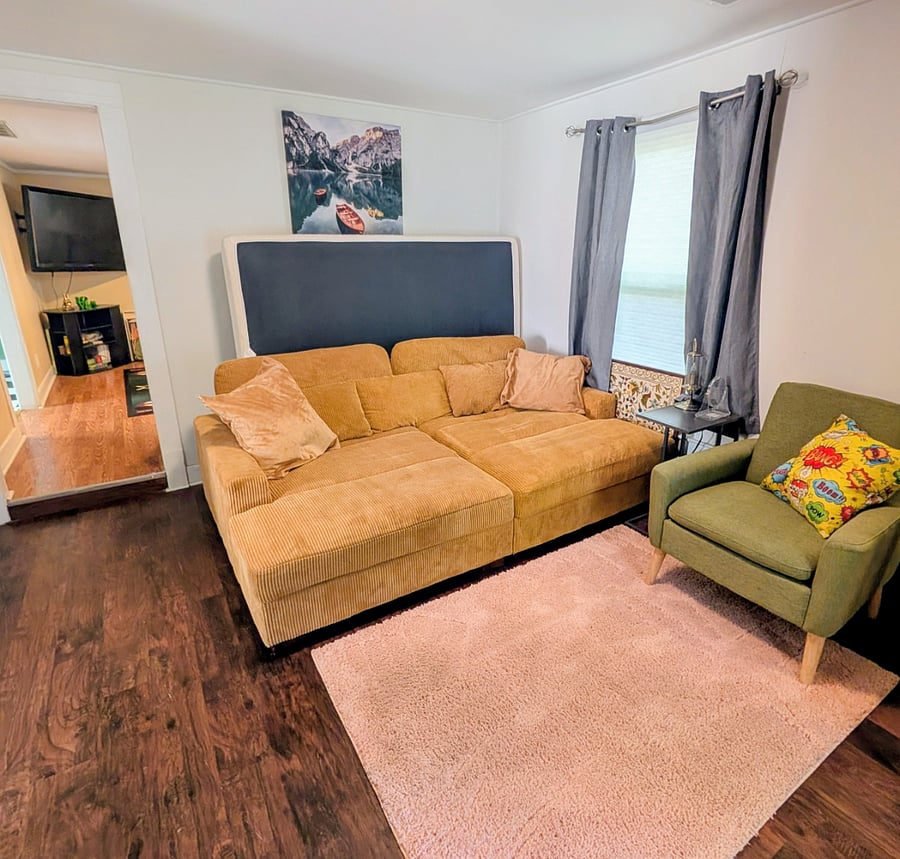 This is the first room you walk into thru the front door. This DEEP couch is a fun place to snuggle but it also sleeps like a Queen bed.