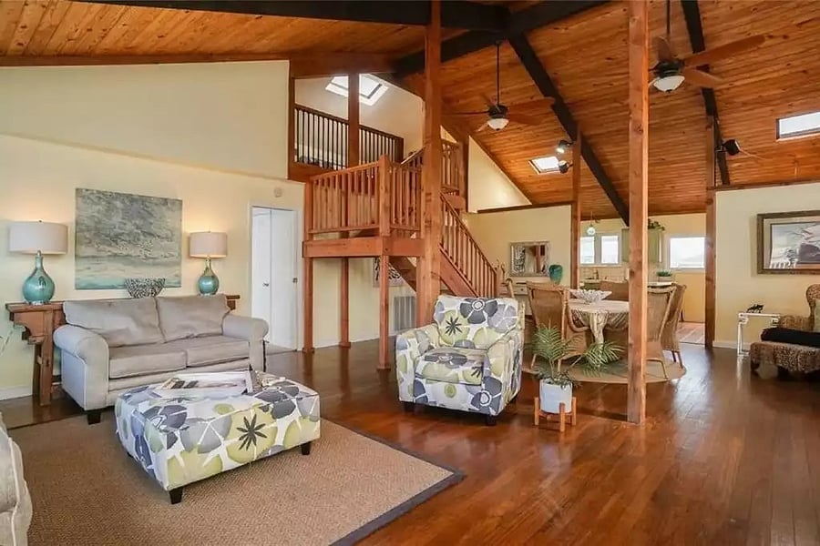 Living room with stairs to the upper bedrooms and loft