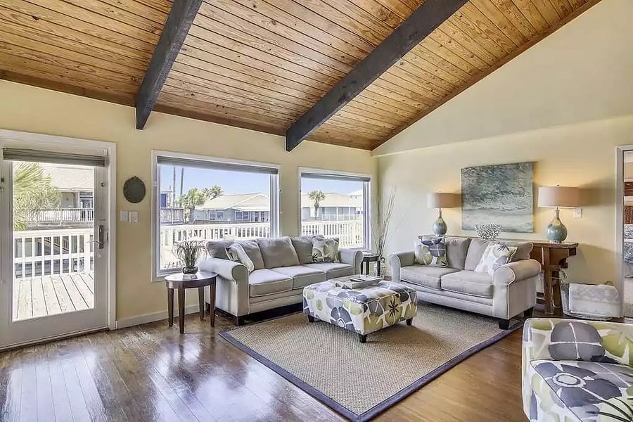 Living room with large windows overlooking the canal and out towards the bay