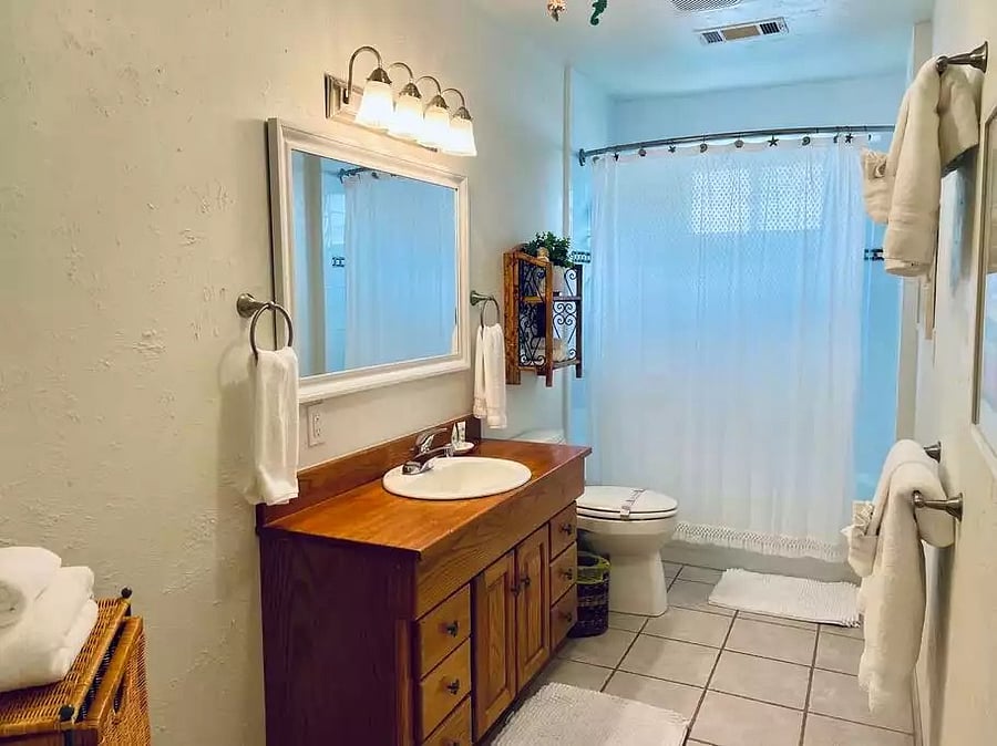 Shared bathroom with tub and shower
