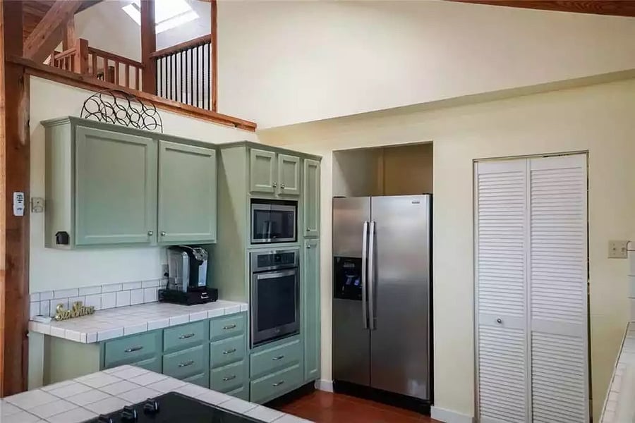 Kitchen includes full size fridge, stove, over, microwave, dishwasher and there are a washer and dryer behind the white doors.