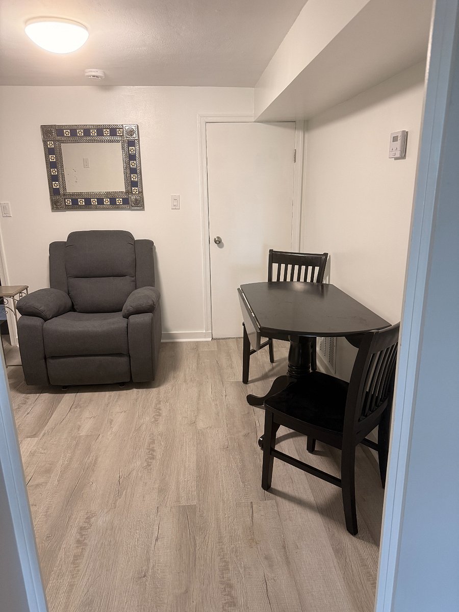 Kitchen lounge with expandable wooden drop-leaf table. 