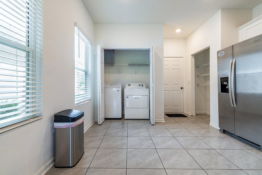 Convenient laundry with full-size washer dryer.