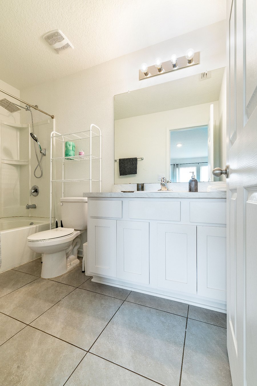 Master bathroom with vanity, shower, and tub.
