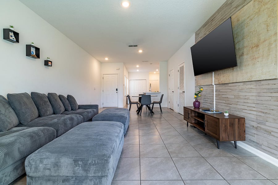 Open concept living and dining with smart TV.