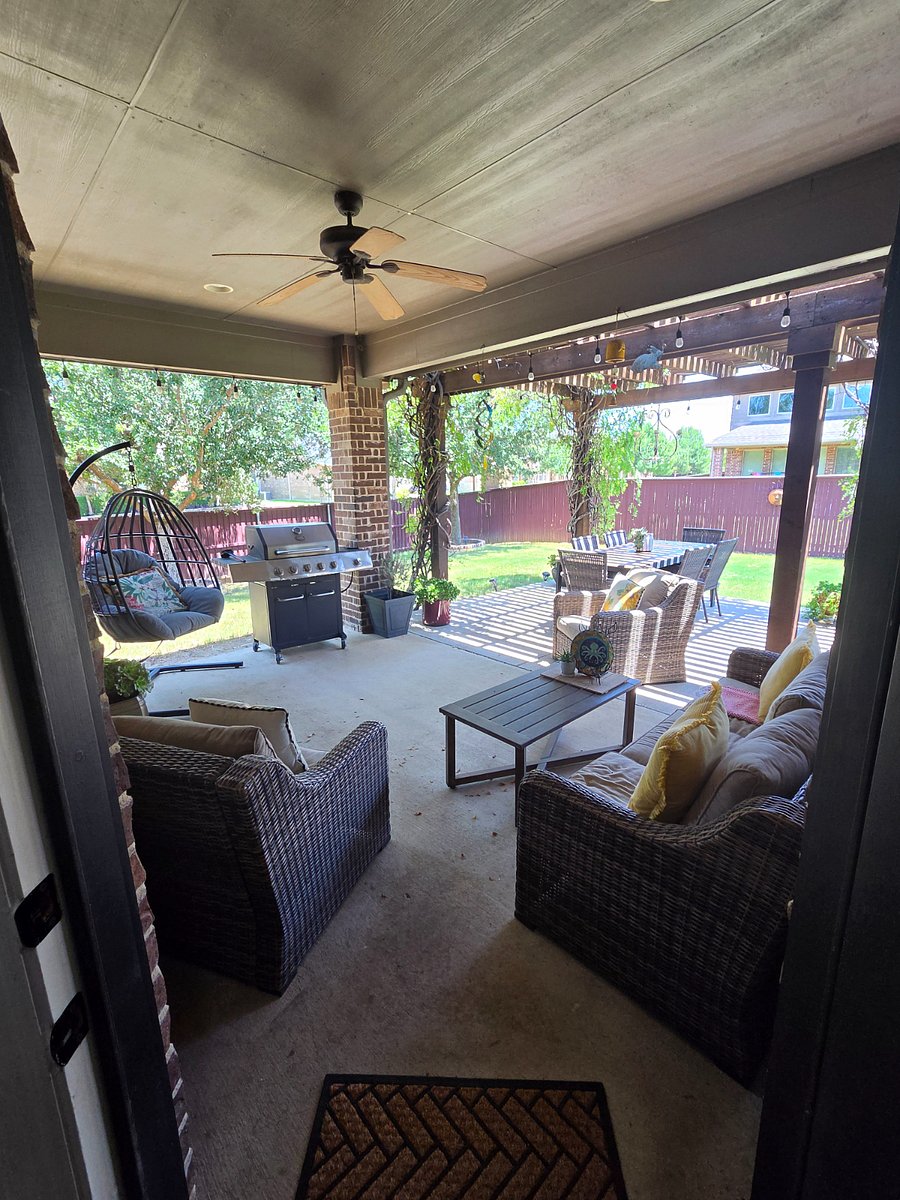 Beautiful covered porch has wisteria growing on the pergola and several trees. Perfect for your morning coffee and at night it can be lit up with lights for windown.