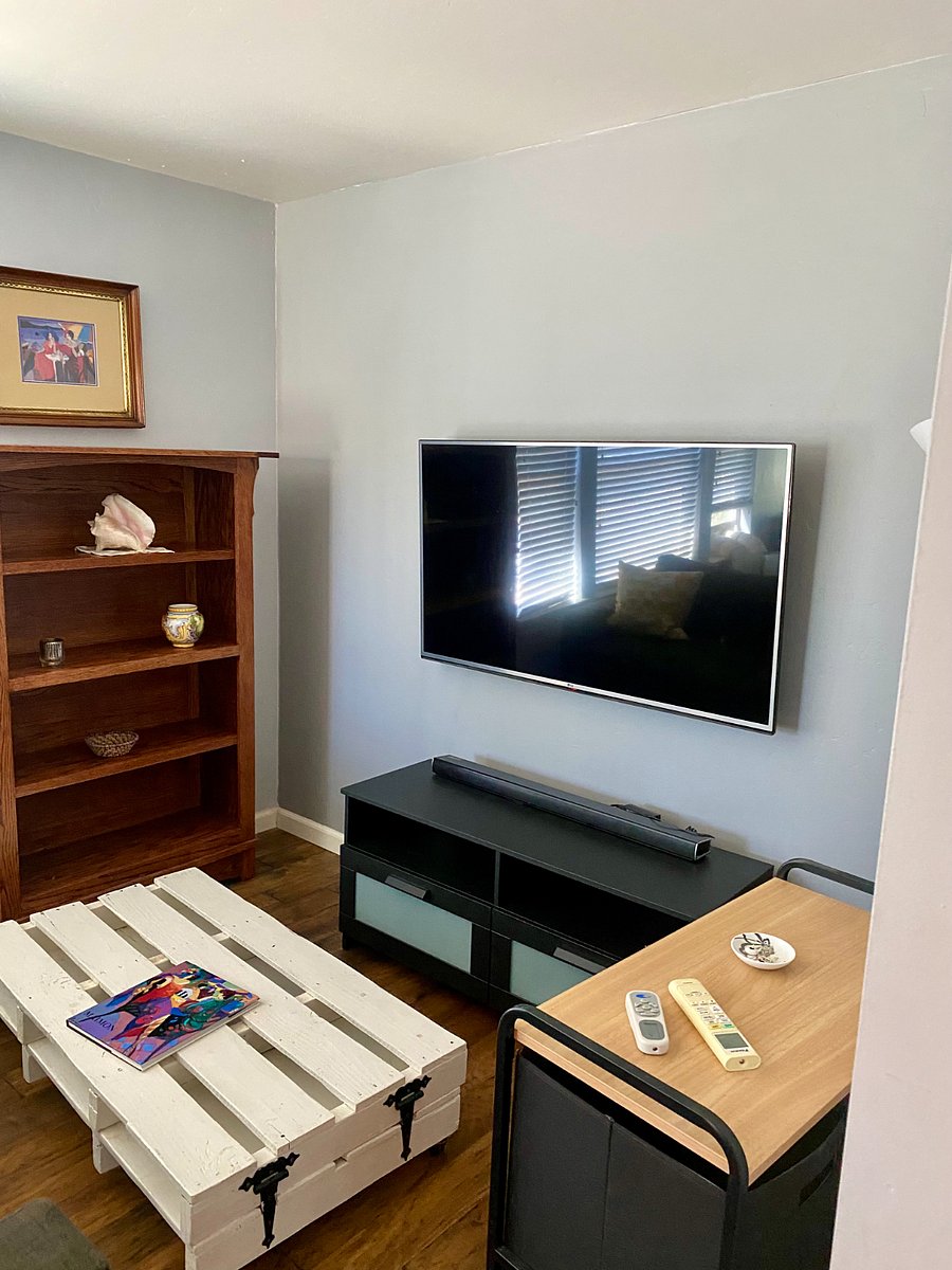 Private living space with flat screen tv, sound bar, loveseat, desk