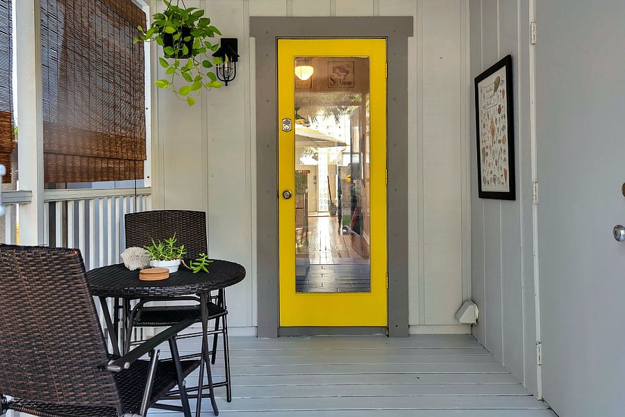 Screened porch, a shaded spot to unwind between indoors and out.